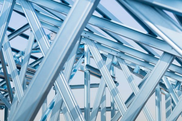 Blue steel framing beams during the construction phase of a house. It represents the industries that Nessco cater to.